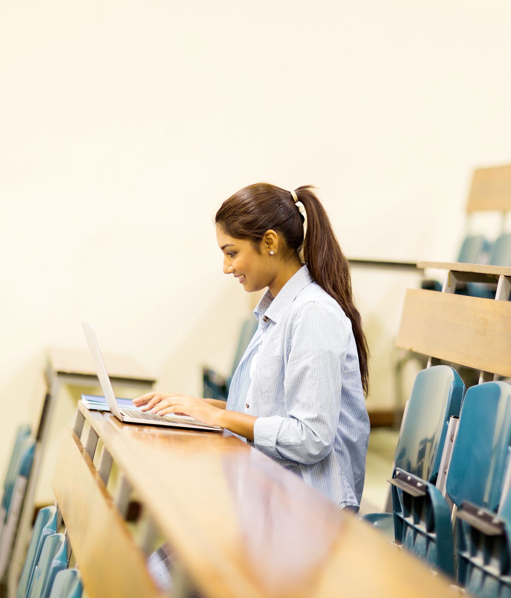 Indian,College,Student,Using,Laptop,Computer,In,Lecture,Hall